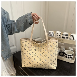 Detail of light beige tote bag with black cartoon bear print and stylish PU leather handles