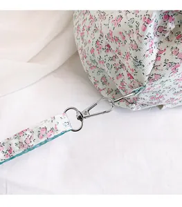 Close-up of the silver twist lock on floral canvas bag with durable stitching details