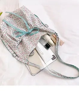 Floral bucket bag interior showing large capacity for phone, lipstick and cosmetics