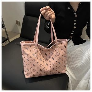 Pink tote bag detail with cute black bear print and litchi grain faux leather texture