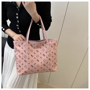 Close-up of pink tote bag featuring black bear patterns and slender shoulder straps