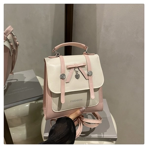 Détail d'un sac à dos en cuir PU rose et blanc avec nœud et pendentif cœur argenté