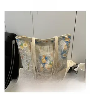 Detail of floral chiffon tote bag with 3D embroidery textures and beige shoulder strap