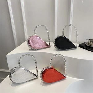 Sparkling heart-shaped clutch bags with rhinestone handles in pink, black, silver, and red