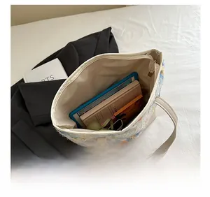Top view of tweed tote bag interior showing large capacity for tablet and notebooks