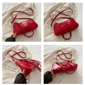 Detail view of red glossy patent leather shoulder bag with magnetic flap and dual straps