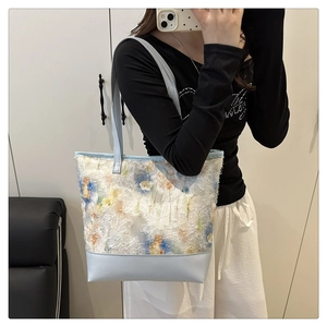Detail of floral chiffon tote bag showing contrast stitching and high capacity design
