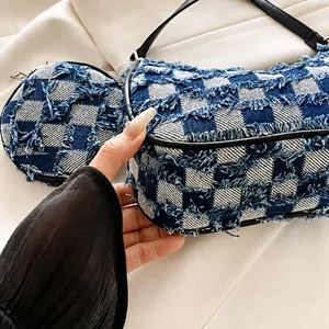 Detail of blue denim checkerboard bag showing frayed edges and precision stitching work