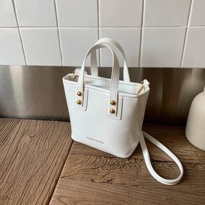 Elegant white bucket bag in textured PU leather with gold hardware and shoulder strap