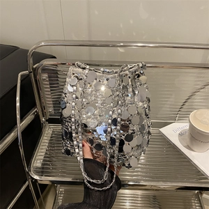 Chic silver sequin bucket bag with metal chain strap for party and evening use