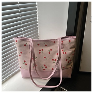 Pink canvas tote bag with cherry print pattern and long shoulder straps for daily use