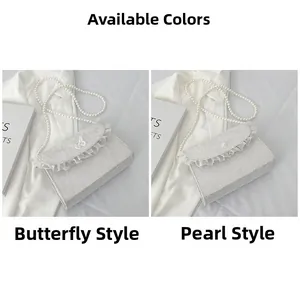 Detail of white lace crossbody bags featuring butterfly embroidery and pearl accents