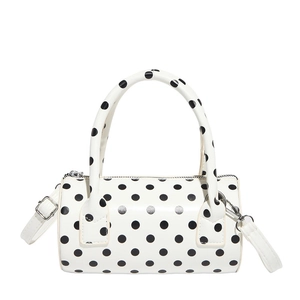 Chic white polka dot cylindrical handbag with top handles and adjustable strap