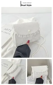 Detail of white lace crossbody bag featuring pearl strap and elegant bow design
