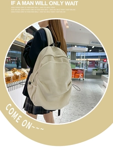 Detail view of large beige corduroy backpack with drawstring side pockets for travel