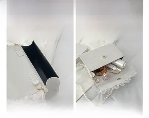 Internal view of a vintage lace pearl handbag showing storage capacity and inner space
