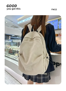 Detailed corduroy texture and side pocket with black drawstring on a beige backpack