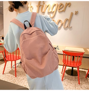 Detail of pink corduroy backpack featuring large capacity and soft textured fabric