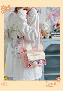 Pink and white crossbody ita bag with cute 3D animal ears and transparent window display