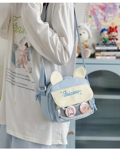 Detail view of light blue and beige canvas bag with cute bear ears and mesh window