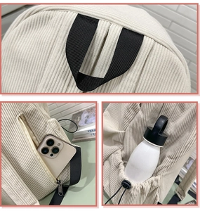Detail of corduroy backpack showing top handle, side bottle pocket and anti-theft back zipper