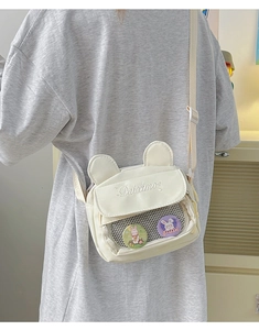 Detail of cute beige canvas shoulder bag with bear ears and transparent window