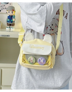 Close-up of yellow canvas crossbody bag with cute bunny ears and clear display window