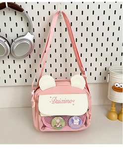 Detail of pink canvas Ita bag with cute animal ears, clear mesh pocket and bunny pins