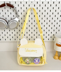 Detail of yellow canvas bag with rabbit ears, embroidery and transparent window display