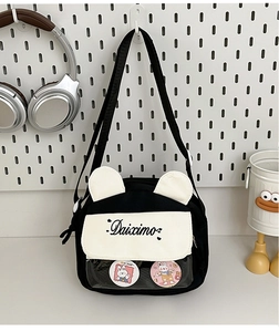 Detail of canvas ita bag with cute 3D ears and clear front pocket for pins