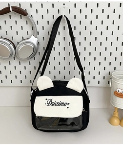 Detail of cute black canvas crossbody bag featuring animal ears and a clear PVC window
