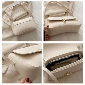Detail shot of cream leather shoulder bag with gold twist lock and interior storage