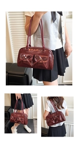 Three-way view of burgundy glossy bow handbag with front pockets and metal rivets