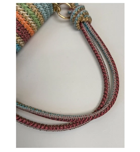 Close-up of multicolored woven straw handbag showing vibrant texture and braided handles