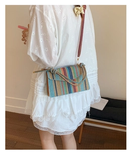 Detail of colorful woven straw bag featuring multi-color stripes and ethnic texture