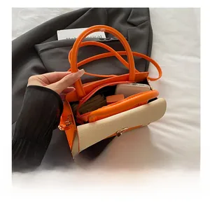 Detail showing high-capacity interior of orange and beige woven textured handbag