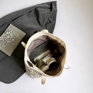 Top view of striped canvas tote bag showing large capacity for laptop and accessories