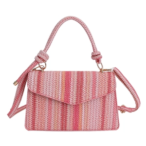 Colorful woven crossbody bag with pink and orange vertical stripes and knot handle detail