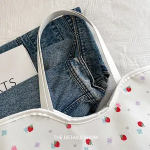 Close-up of floral tote bag with strawberry prints showing spacious capacity for clothing