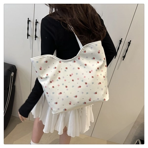 Detail shot of the large capacity shoulder tote bag with fresh strawberry and floral prints