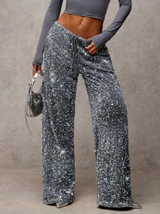 Detailed view of shimmering silver sequins and drawstring on wide leg pants