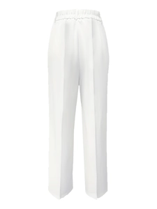 Detail view of white high-waisted wide-leg trousers featuring vertical creases and soft drape