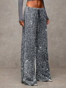 Close-up of silver sequin wide-leg pants with drawstring waist and shimmering texture