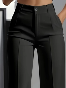 Detail of high waisted black dress pants showing single button closure and pleat detail
