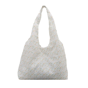 White canvas tote bag with yellow floral print and white lace embroidery details
