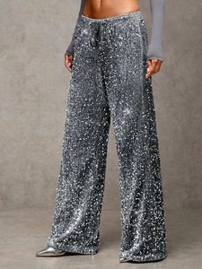 Detail shot of shimmering silver sequin wide leg pants with an adjustable drawstring waist