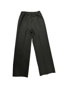 Detail of high waist elastic waistband and sharp creases on black wide leg trousers