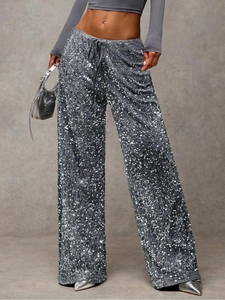 Detail of high-density silver sequins and adjustable black drawstring on wide-leg pants