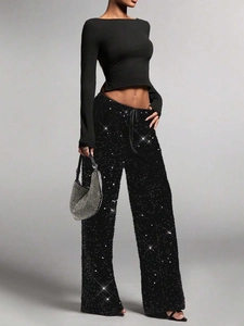 Detailed view of shimmering black sequin trousers with adjustable drawstring elastic waist