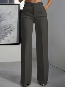 Detailed view of dark grey high-waisted trousers with precise front crease and smooth drape